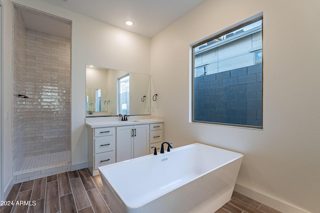 full bathroom with a soaking tub, vanity, walk in shower, and wood tiled floor