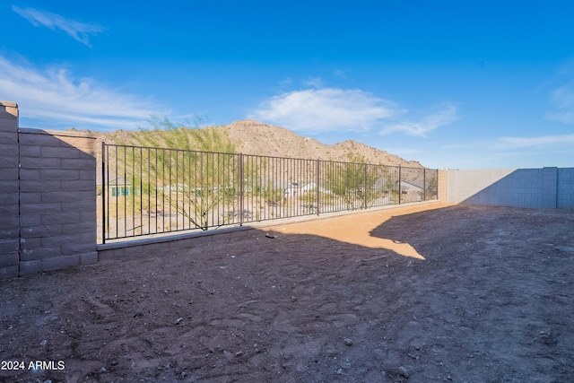 view of yard with a mountain view and fence