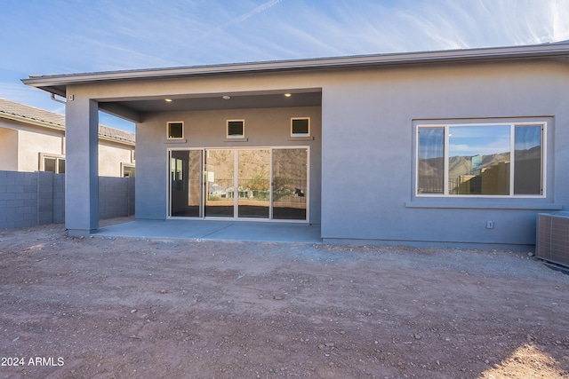 back of house with a patio, central air condition unit, fence, and stucco siding