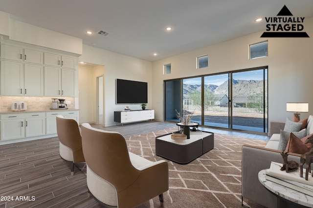 living area featuring dark wood finished floors, visible vents, and recessed lighting