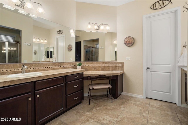 bathroom with tasteful backsplash, vanity, and a shower with shower door