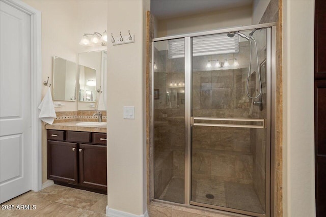 bathroom featuring tile patterned flooring, vanity, and a shower with door