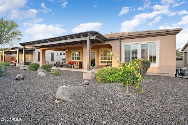 rear view of house with an outdoor living space, a pergola, ceiling fan, and a patio area