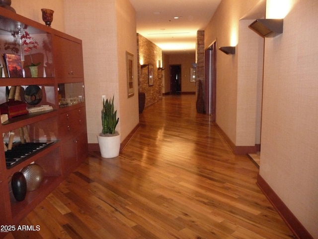 corridor with hardwood / wood-style floors