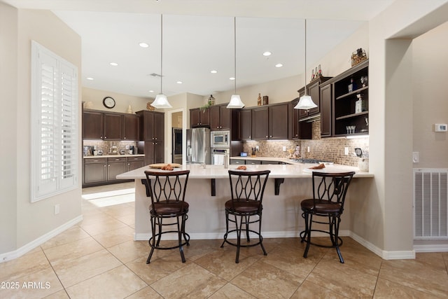 12935 W Lone Tree Trl, Peoria, AZ 85383 - kitchen with dark brown cabinetry, stainless steel appliances, open shelves, backsplash, and visible vents