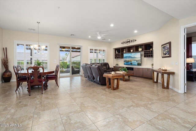 living room with ceiling fan with notable chandelier