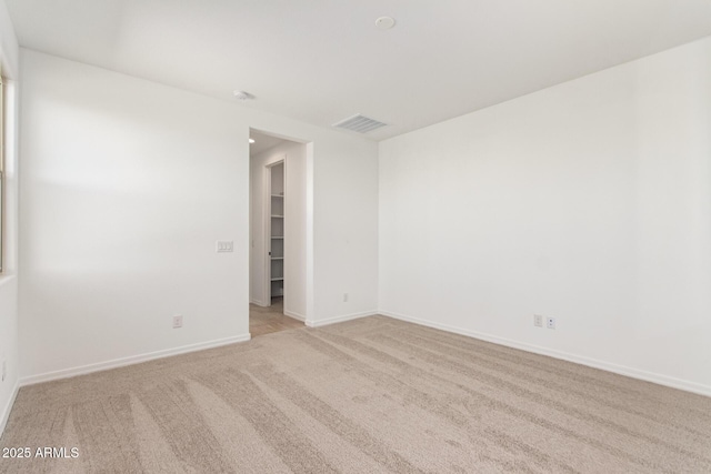 unfurnished room featuring light carpet