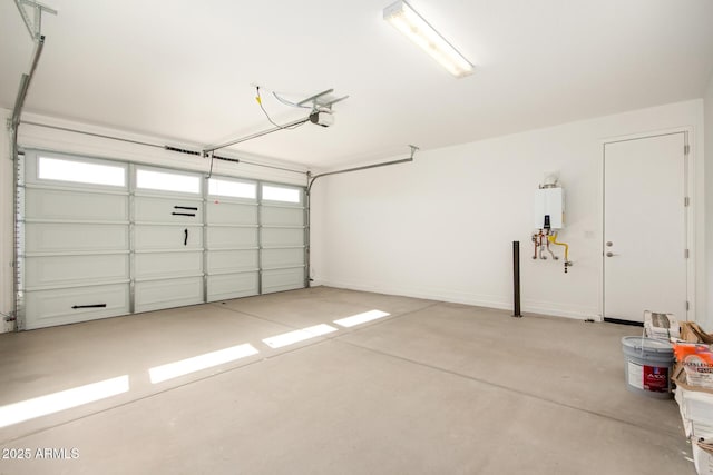 garage featuring a garage door opener and tankless water heater