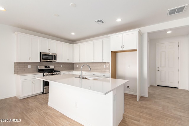 kitchen featuring white cabinets, appliances with stainless steel finishes, and sink