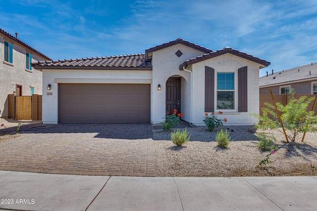 mediterranean / spanish home featuring a garage