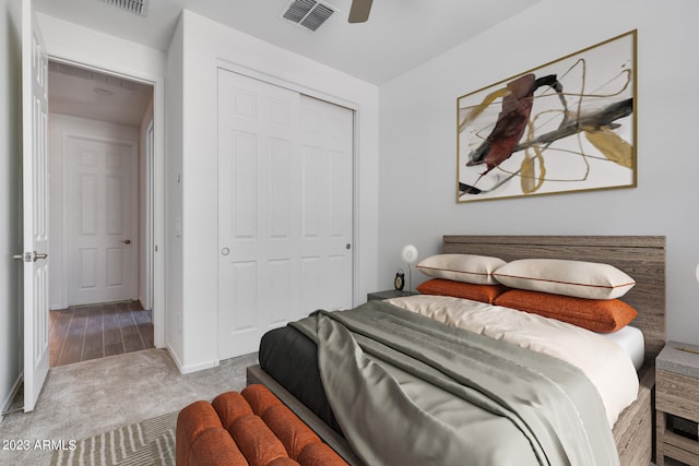 bedroom with light colored carpet, a closet, and ceiling fan