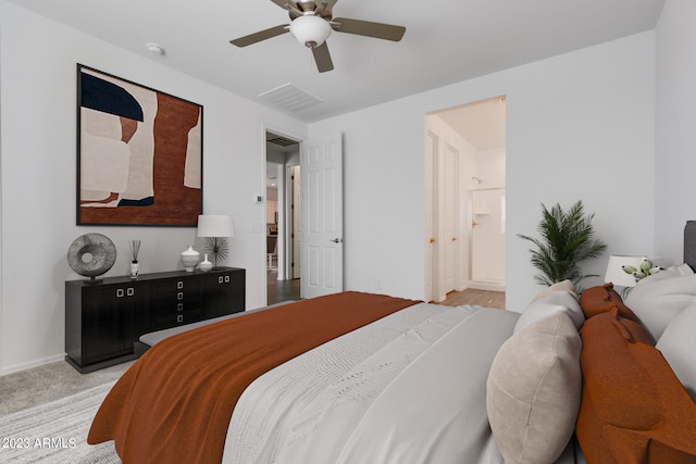 carpeted bedroom featuring ceiling fan and ensuite bath