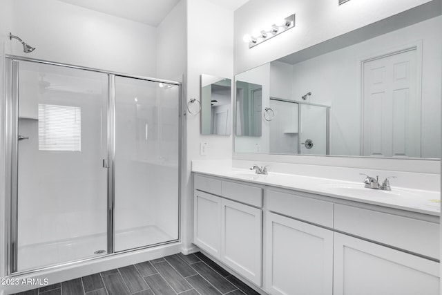 bathroom with double sink vanity and walk in shower