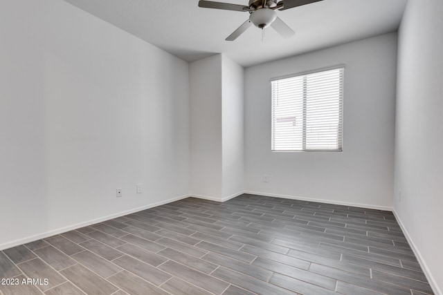 unfurnished room featuring dark hardwood / wood-style floors and ceiling fan