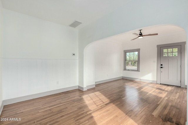 unfurnished living room with hardwood / wood-style flooring and ceiling fan