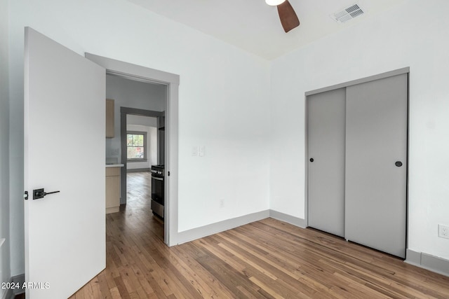 unfurnished bedroom with a closet, ceiling fan, and light hardwood / wood-style flooring