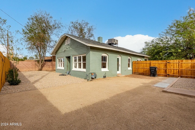 rear view of house featuring cooling unit