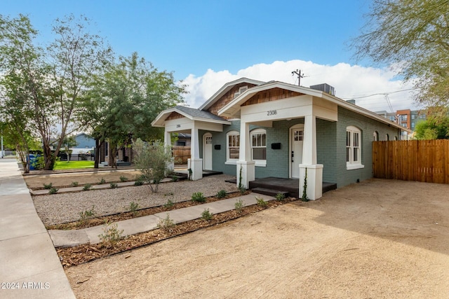 bungalow-style home with central AC unit and covered porch