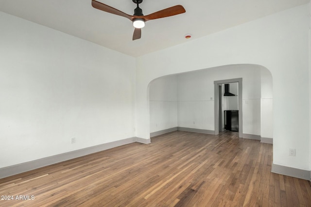 empty room with hardwood / wood-style flooring and ceiling fan