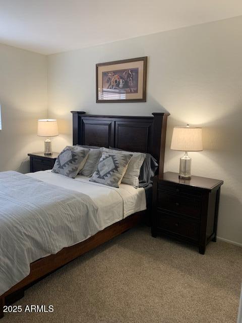 bedroom featuring light colored carpet