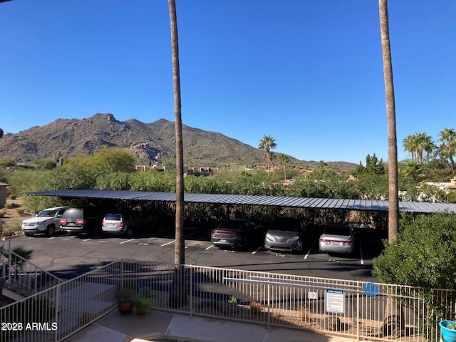 view of vehicle parking with a carport and a mountain view