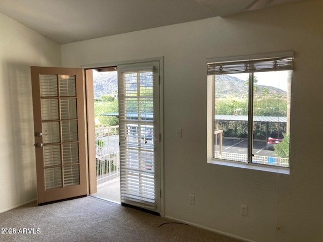 doorway featuring carpet flooring and a mountain view