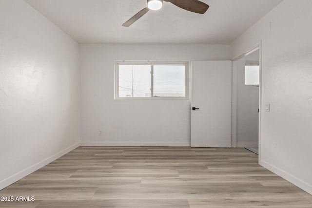 spare room featuring ceiling fan and light wood-type flooring