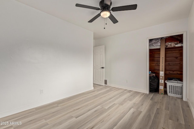 unfurnished bedroom with light hardwood / wood-style floors, a closet, and ceiling fan