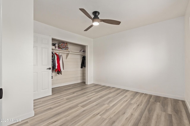 unfurnished bedroom with light hardwood / wood-style floors, a closet, and ceiling fan