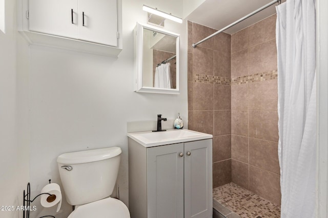 bathroom featuring vanity, curtained shower, and toilet