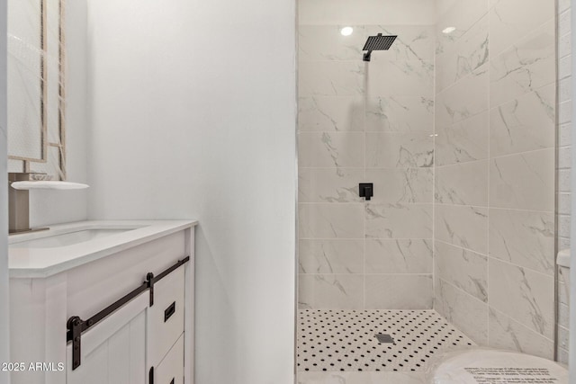 bathroom featuring vanity and a tile shower