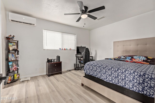 bedroom featuring ceiling fan, light hardwood / wood-style floors, and a wall mounted AC