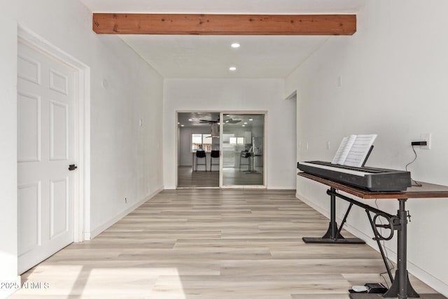 miscellaneous room with beam ceiling and light hardwood / wood-style flooring