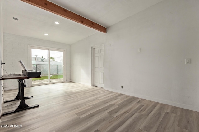 exercise room with light wood-type flooring