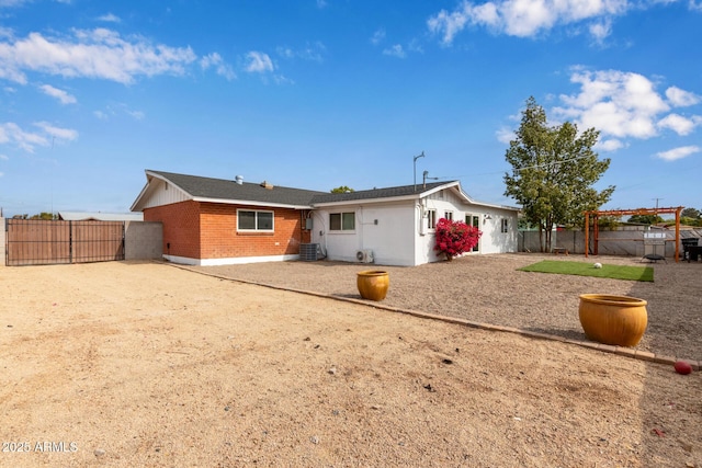 rear view of house with central AC and a patio