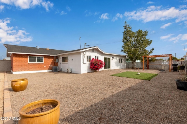 back of house with central AC and a pergola