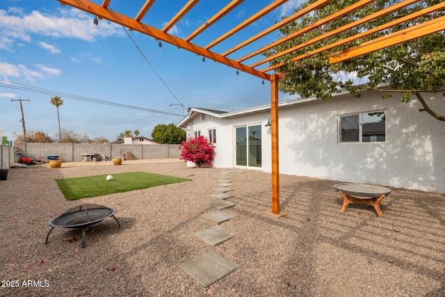 view of patio / terrace with a pergola and a fire pit