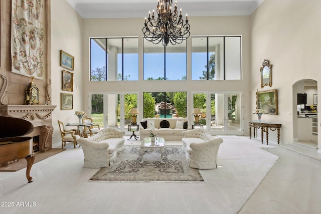 6467 E Sierra Vista Dr, Paradise Valley, AZ 85253 - living room with arched walkways, a high ceiling, a chandelier, and french doors