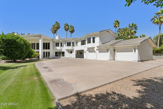 6467 E Sierra Vista Dr, Paradise Valley, AZ 85253 - neoclassical / greek revival house with concrete driveway, an attached garage, and stucco siding
