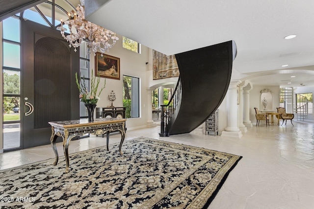 6467 E Sierra Vista Dr, Paradise Valley, AZ 85253 - entrance foyer featuring stairs, ornate columns, recessed lighting, arched walkways, and a notable chandelier