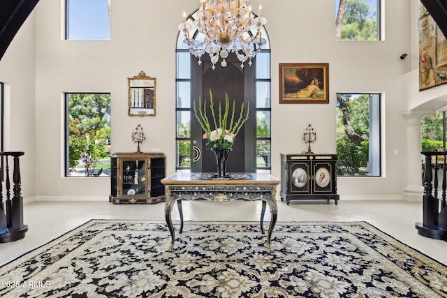 6467 E Sierra Vista Dr, Paradise Valley, AZ 85253 - living area with an inviting chandelier, baseboards, a high ceiling, and tile patterned flooring