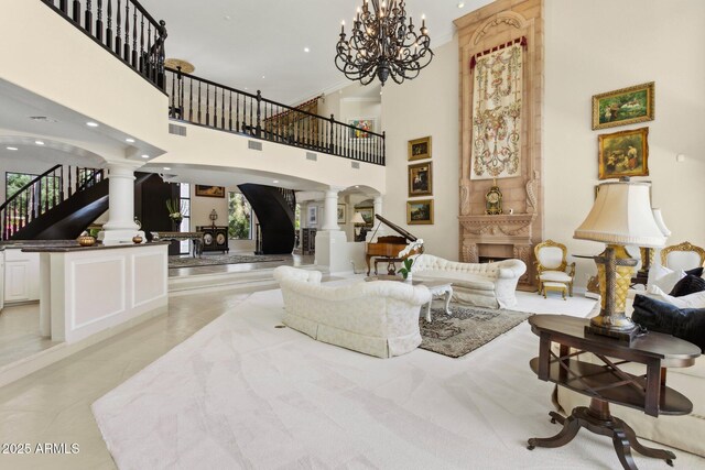 6467 E Sierra Vista Dr, Paradise Valley, AZ 85253 - living area featuring ornate columns, a high ceiling, visible vents, and stairway