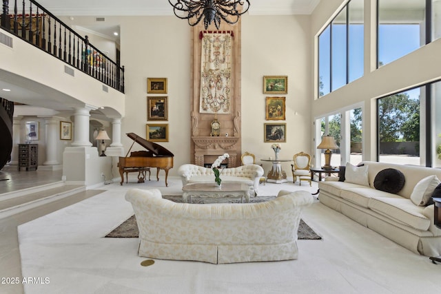 6467 E Sierra Vista Dr, Paradise Valley, AZ 85253 - living area with ornamental molding, a notable chandelier, ornate columns, and a towering ceiling