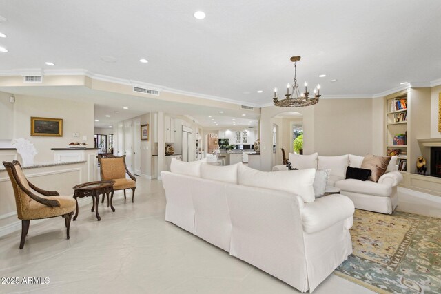6467 E Sierra Vista Dr, Paradise Valley, AZ 85253 - living area with crown molding, a notable chandelier, arched walkways, built in shelves, and visible vents