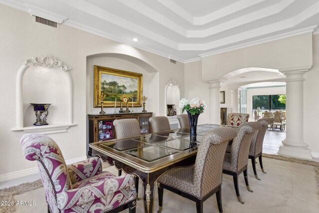 6467 E Sierra Vista Dr, Paradise Valley, AZ 85253 - dining space with decorative columns, visible vents, arched walkways, light carpet, and a tray ceiling