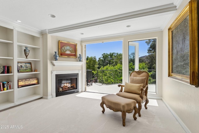 6467 E Sierra Vista Dr, Paradise Valley, AZ 85253 - sitting room featuring ornamental molding, built in features, a glass covered fireplace, baseboards, and carpet