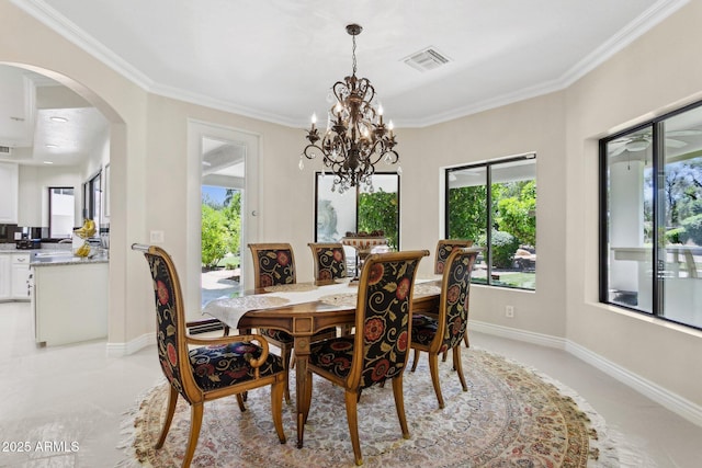 6467 E Sierra Vista Dr, Paradise Valley, AZ 85253 - dining area with visible vents, crown molding, arched walkways, a notable chandelier, and a wealth of natural light