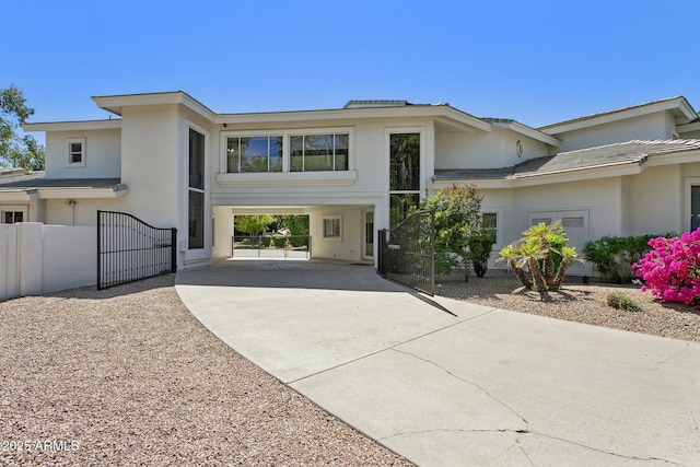 6467 E Sierra Vista Dr, Paradise Valley, AZ 85253 - view of front of house with fence, stucco siding, a gate, concrete driveway, and a carport