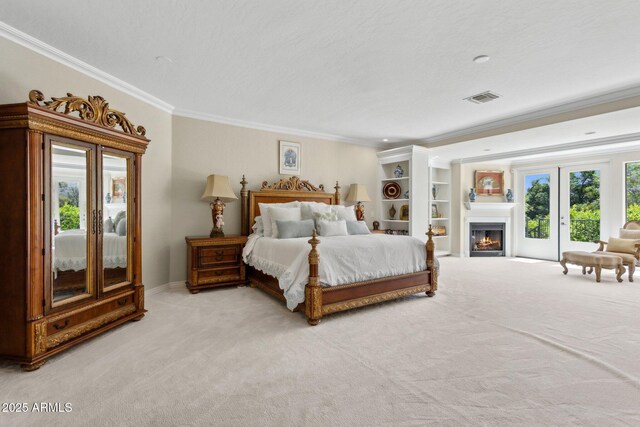 6467 E Sierra Vista Dr, Paradise Valley, AZ 85253 - carpeted bedroom featuring crown molding, access to outside, a lit fireplace, and visible vents