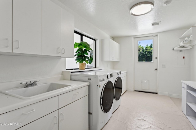 6467 E Sierra Vista Dr, Paradise Valley, AZ 85253 - laundry room with cabinet space, washing machine and dryer, a sink, and a wealth of natural light